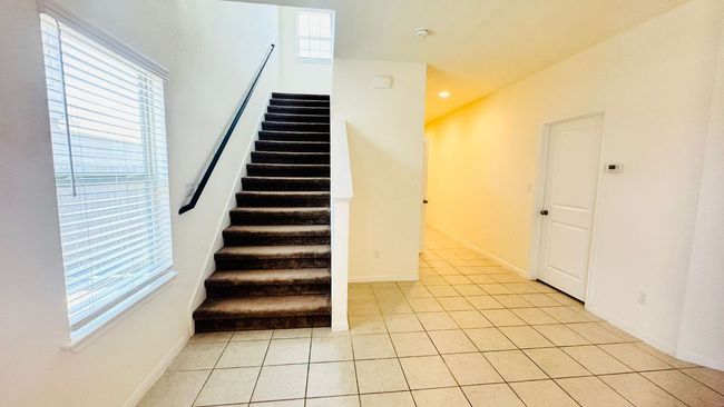 Stairway featuring tile patterned flooring and baseboards | Image 14