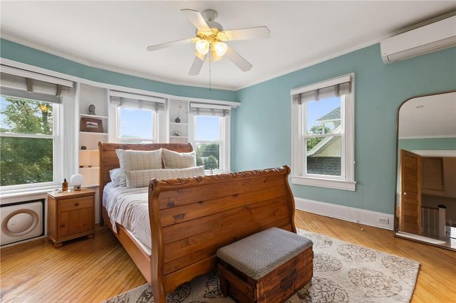 The primary bedroom with loads of natural light and ceiling fan | Image 14