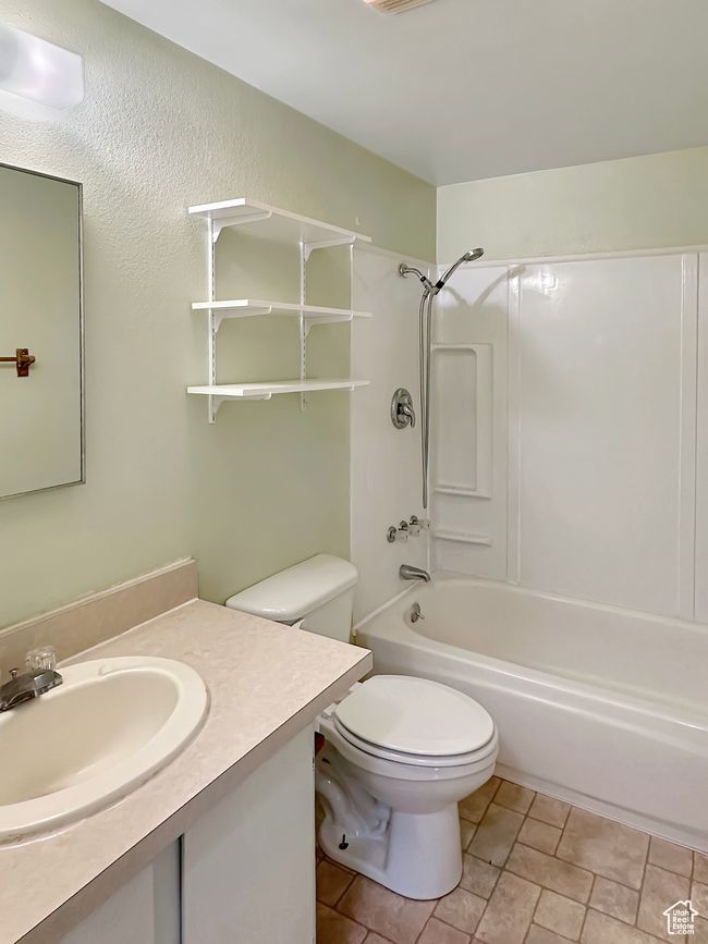 Bathroom with toilet, shower / tub combination, and vanity | Image 15