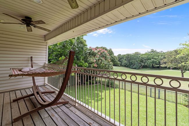 Walk-out balcony featuring ceiling fan and view of golf course | Image 26