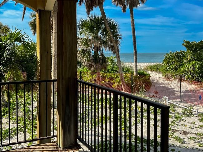 Balcony featuring a water view and a beach view | Image 24