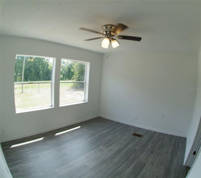 Master Bedroom with 2 windows, ceiling fan, and laminate flooring | Image 26