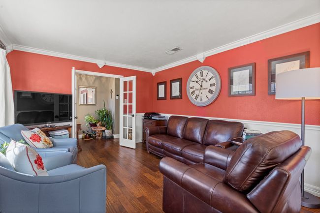 Living room with dark hardwood / wood-style floors, ornamental molding, and french doors | Image 5