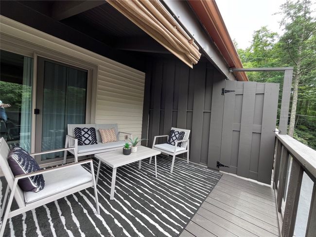 Partially covered deck with privacy fencing. | Image 10