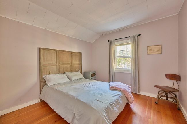 Bedroom with baseboards, vaulted ceiling, and light wood-type flooring | Image 14