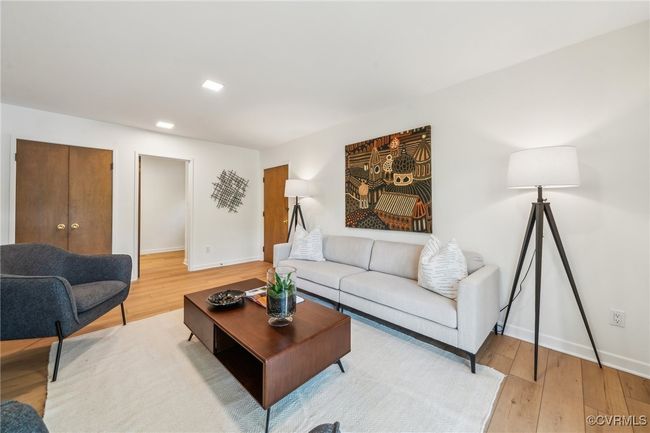 Living area with baseboards, recessed lighting, and light wood-style floors | Image 10