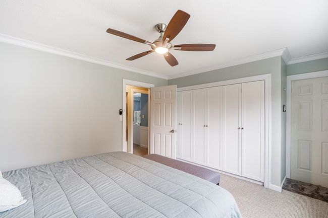 Unfurnished bedroom featuring carpet flooring, a ceiling fan, ornamental molding, and a closet | Image 18
