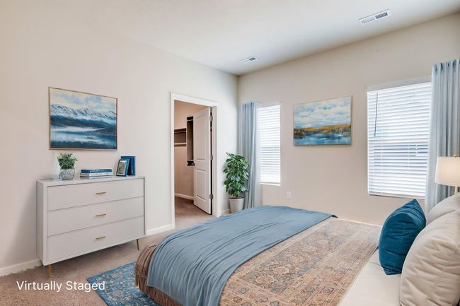Bedroom with carpet floors and a walk in closet | Image 12