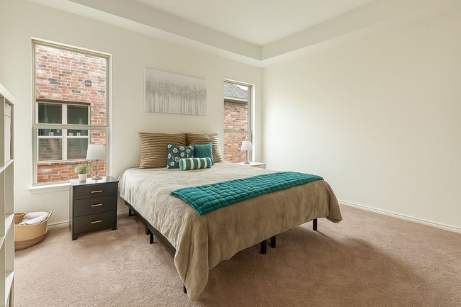 Bedroom featuring light carpet and baseboards | Image 9