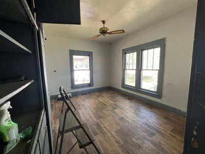 Unfurnished living room featuring plenty of natural light, hardwood / wood-style floors, and ceiling fan | Image 3