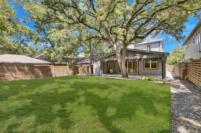 Rear view of property featuring a yard, a fenced backyard, and a patio area | Image 31