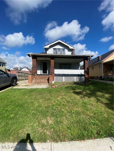 View of front of house featuring covered porch and a front yard | Image 1