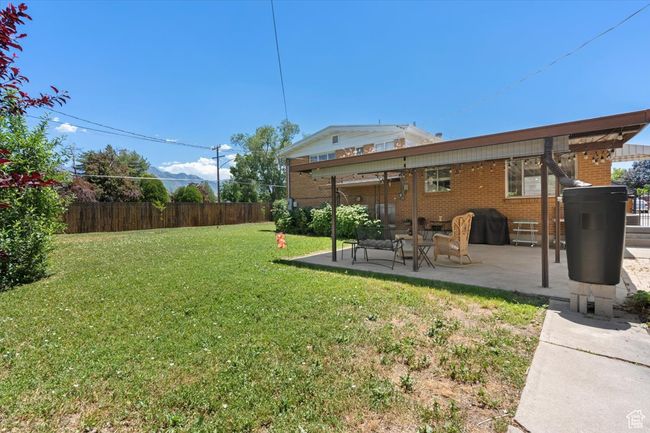 View of yard with a patio and rain barrel | Image 26