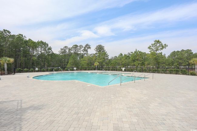 Pool with a patio area and fence | Image 31