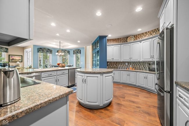 kitchen featuring appliances with stainless steel finishes, wood finished floors, a healthy amount of sunlight, and recessed lighting | Image 35