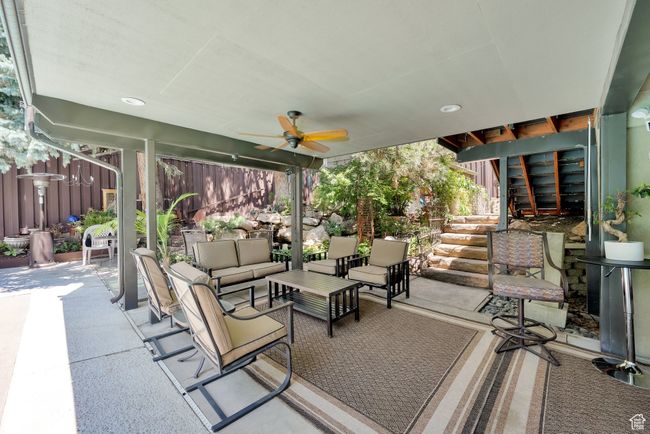 View of patio / terrace featuring an outdoor living space, a ceiling fan, and stairs | Image 23