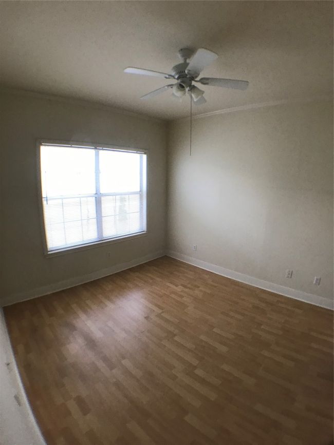 Spare room featuring ceiling fan, baseboards, and wood finished floors | Image 4