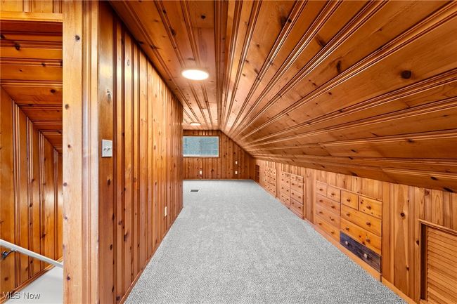 Bonus room featuring carpet flooring, wood walls, wooden ceiling, and vaulted ceiling | Image 27