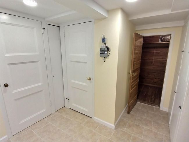 Hall featuring light tile patterned floors and baseboards | Image 35