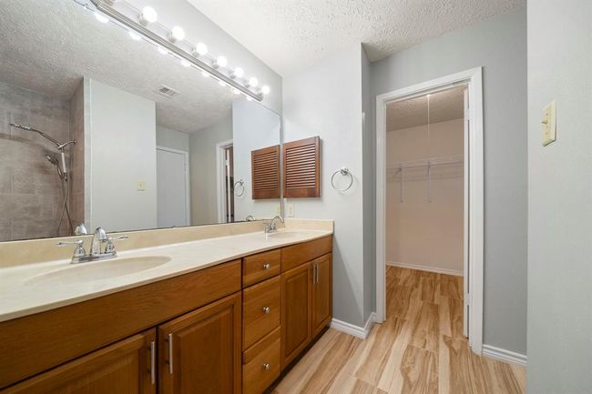 Convenient access to the walk-in closet and a walk-in shower make this bathroom functional for everyday routines. | Image 23