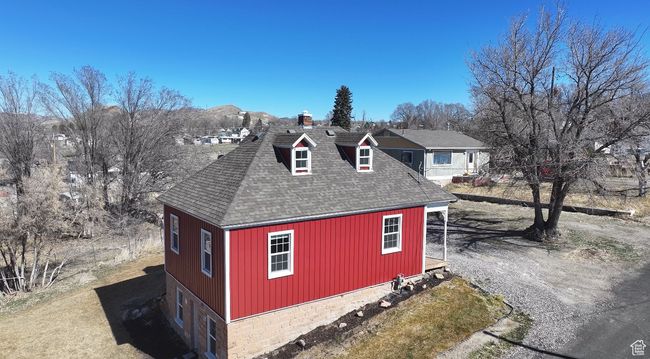 View of home's exterior with a garage and roof with shingles | Image 39