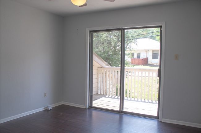 Spare room featuring wood finished floors, baseboards, and ceiling fan | Image 17
