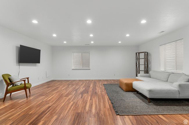 Large basement living area with full sized windows. | Image 15