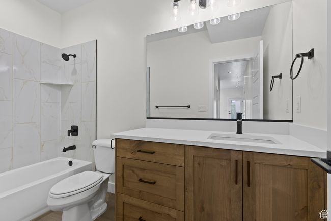 Full bath featuring toilet, vanity, and shower / bathtub combination | Image 19