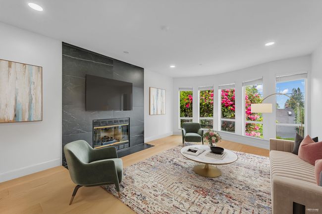 Living area with a fireplace, recessed lighting, baseboards, and wood finished floors | Image 25