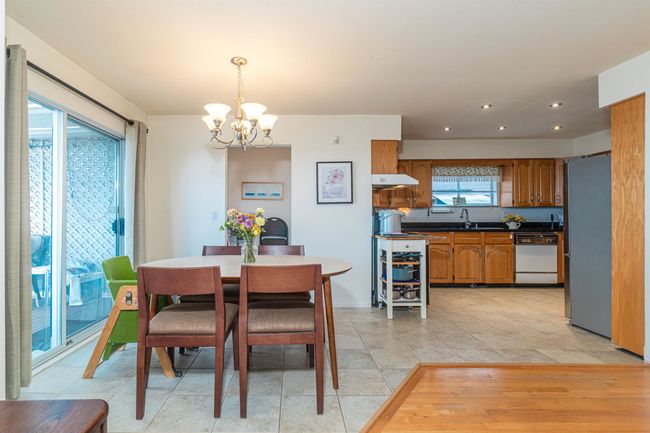 Dining area featuring a chandelier, light tile patterned floors, and recessed lighting | Image 14