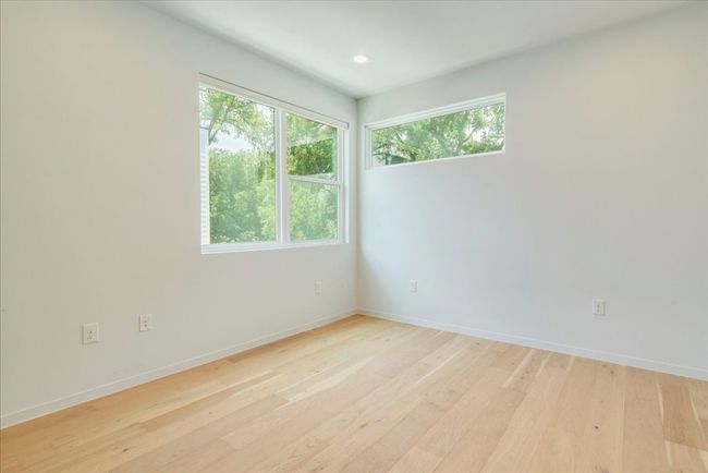 Empty room featuring plenty of natural light, light wood-style floors, and recessed lighting | Image 18