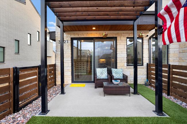 Fenced backyard with a patio, a pergola, and a residential view | Image 23