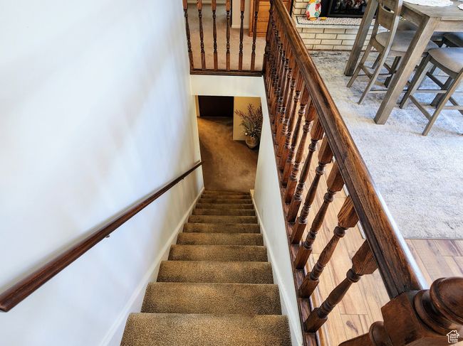Staircase featuring carpet floors and a fireplace | Image 28