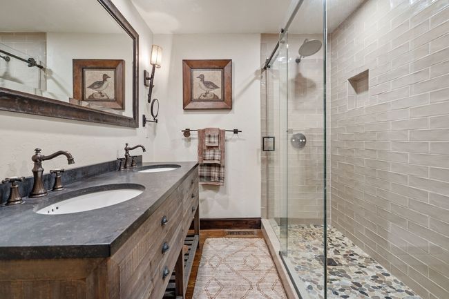 Bathroom with a stall shower, double vanity, and a sink | Image 46
