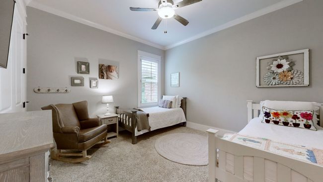 This main-level second bedroom is full of charm with tall ceilings, neutral tones, and natural light—ideal for guests, kids, or a cozy retreat with easy access to the full bath nearby. | Image 36