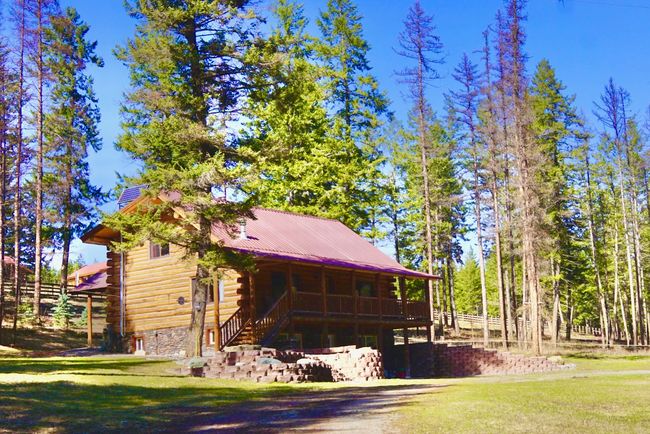 View of home's exterior featuring log siding and a lawn | Image 8