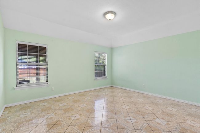 Unfurnished room featuring baseboards and tile patterned floors | Image 11
