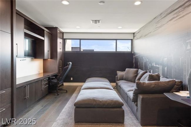 Office featuring visible vents, light wood-style floors, built in desk, and recessed lighting | Image 24