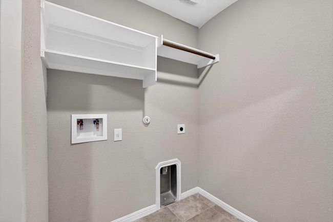 Laundry room featuring electric dryer hookup, washer hookup, hookup for a gas dryer, and tile patterned floors | Image 35