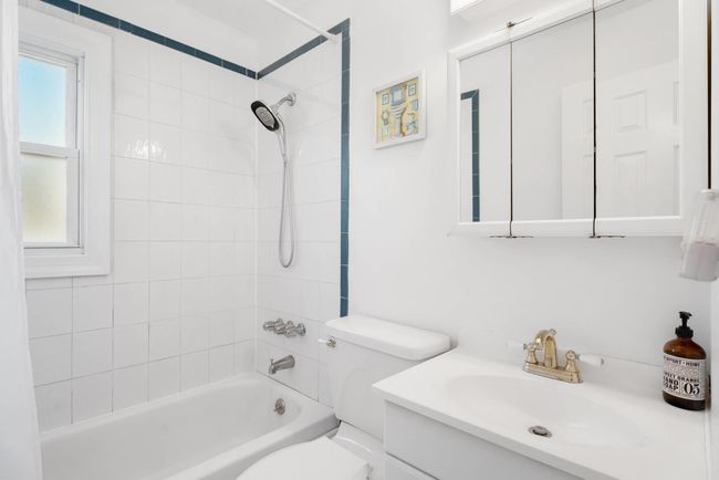 Full bathroom with tiled shower / bath combo, vanity, and toilet | Image 19