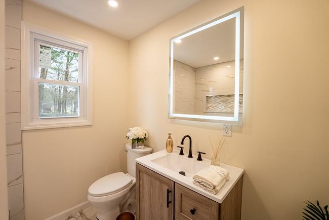 Bathroom with baseboards, toilet, recessed lighting, vanity, and marble finish floor | Image 22