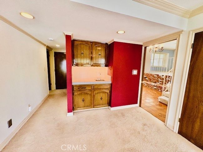 Wet bar in den between foyer and hallway to downstairs bedroom | Image 20