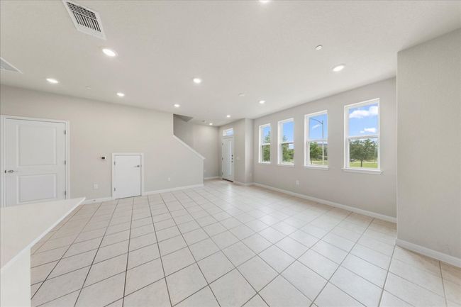 Empty room with recessed lighting, baseboards, and light tile patterned flooring | Image 7