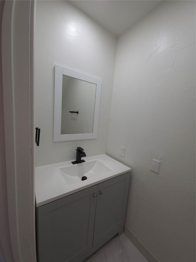 Bathroom with vanity and marble finish floors | Image 9