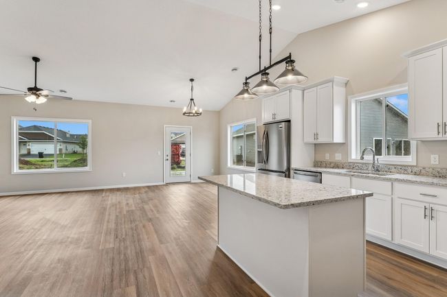 Well equipped and open Kitchen with walk-in pantry, island, soft close cabinetry, granite countertops and gorgeous luxury wide plank floors and vaulted ceilings. | Image 4
