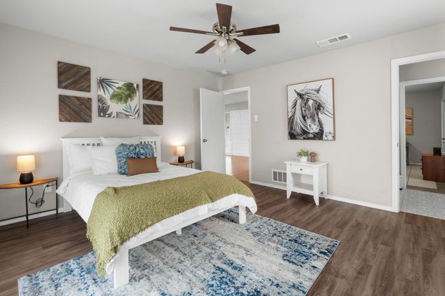 Bedroom featuring wood finished floors, baseboards, and a ceiling fan | Image 14