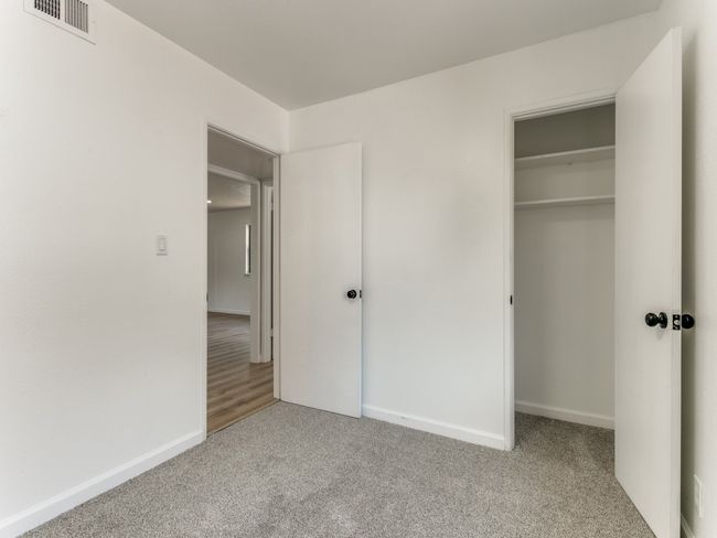 Unfurnished bedroom featuring visible vents, carpet floors, and baseboards | Image 7