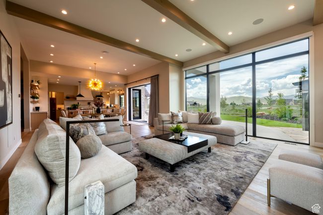 Living room with a chandelier, beam ceiling, recessed lighting, and wood finished floors | Image 14