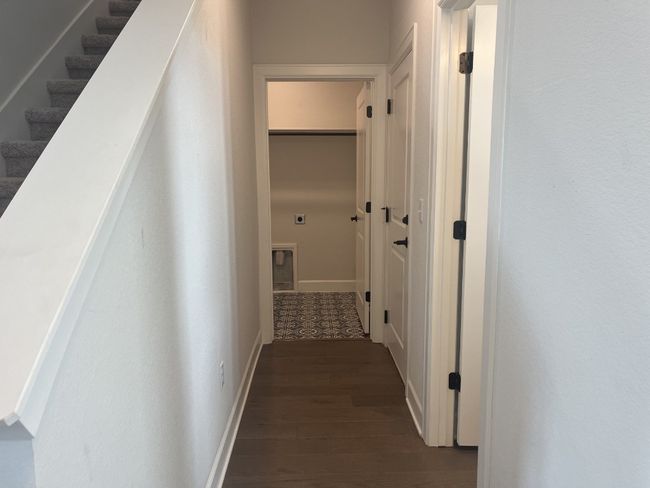Hallway featuring baseboards and dark wood-style floors | Image 24