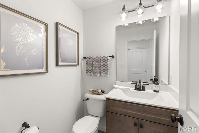 Half bathroom featuring toilet and vanity | Image 15